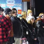 The Class Act Drama Troupe entertains the crowd with singing Saturday, Dec. 7, 2019, at the Christmas in the Park celebration at Soldotnat Creek Park in Soldotna, Alaska. (Photo by Joey Klecka/Peninsula Clarion)