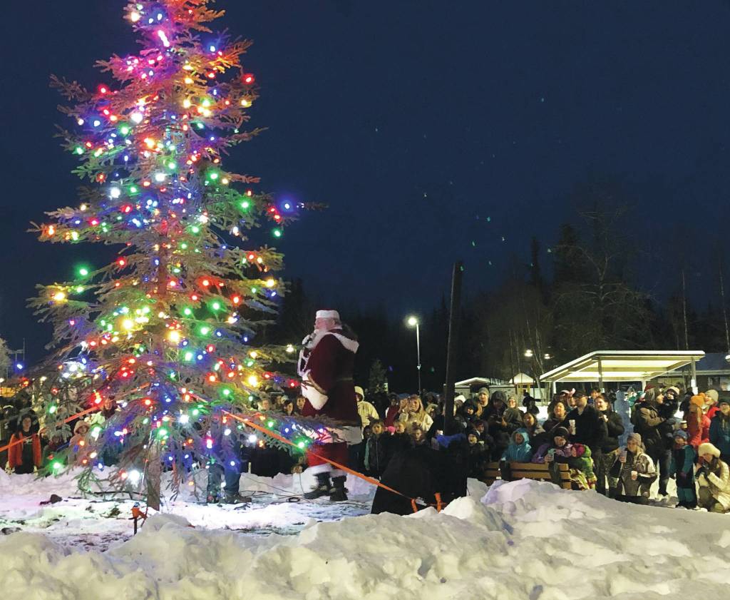 Santa Claus lights up the Christmas tree in front of an audience Saturday, Dec. 7, 2019, at the Christmas in the Park Celebration at Soldotna Creek Park in Soldotna, Alaska. (Photo by Joey Klecka/Peninsula Clarion)
