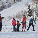 A group of Kenai Central High School skiers teach lessons to youth skiers Saturday at the Black Stone Axe Ridge Warm Up Rally at the Tsalteshi Trails in Soldotna. (Photo by Joey Klecka/Peninsula Clarion)