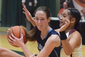 Soldotnas Danica Schmidt (left) drives into the lane by Dimonds Dshanna Schuster Friday, March 22, 2019, in the Class 4A state basketball tournament at the Alaska Airlines Center in Anchorage. (Photo by Joey Klecka/Peninsula Clarion)