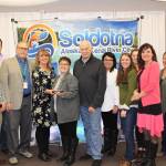 Staff and board members of Peninsula Community Health Services smile for the camera at the Soldotna Chamber of Commerce Awards Luncheon at the Soldotna Regional Sports Complex on Dec. 11, 2019. (Photo by Brian Mazurek/Peninsula Clarion)