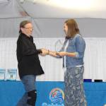 Paul Wright accepts his Excellence in Profession Award from incoming Chamber President Pamela Parker at the Soldotna Chamber of Commerce Awards Luncheon at the Soldotna Regional Sports Complex on Dec. 11, 2019. (Photo by Brian Mazurek/Peninsula Clarion)