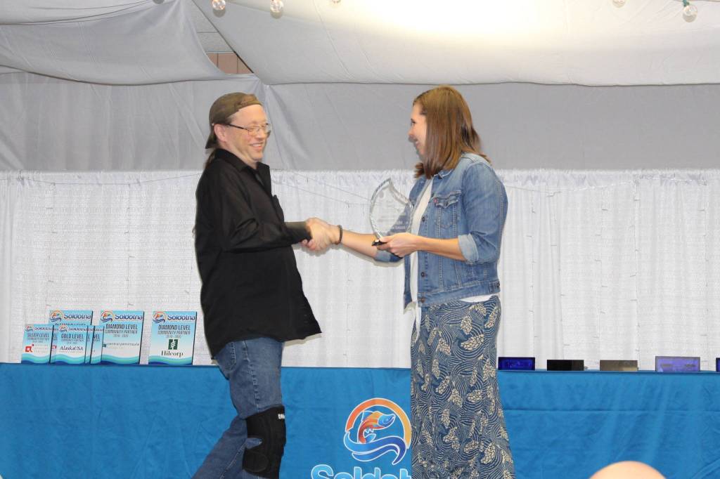 Paul Wright accepts his Excellence in Profession Award from incoming Chamber President Pamela Parker at the Soldotna Chamber of Commerce Awards Luncheon at the Soldotna Regional Sports Complex on Dec. 11, 2019. (Photo by Brian Mazurek/Peninsula Clarion)