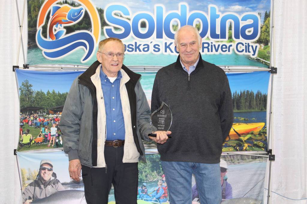 Pioneer Award winner Kearlee Wright and Chamber President Jim Stogsdill smile for the camera at the Soldotna Chamber of Commerce Awards Luncheon at the Soldotna Regional Sports Complex on Dec. 11, 2019. (Photo by Brian Mazurek/Peninsula Clarion)