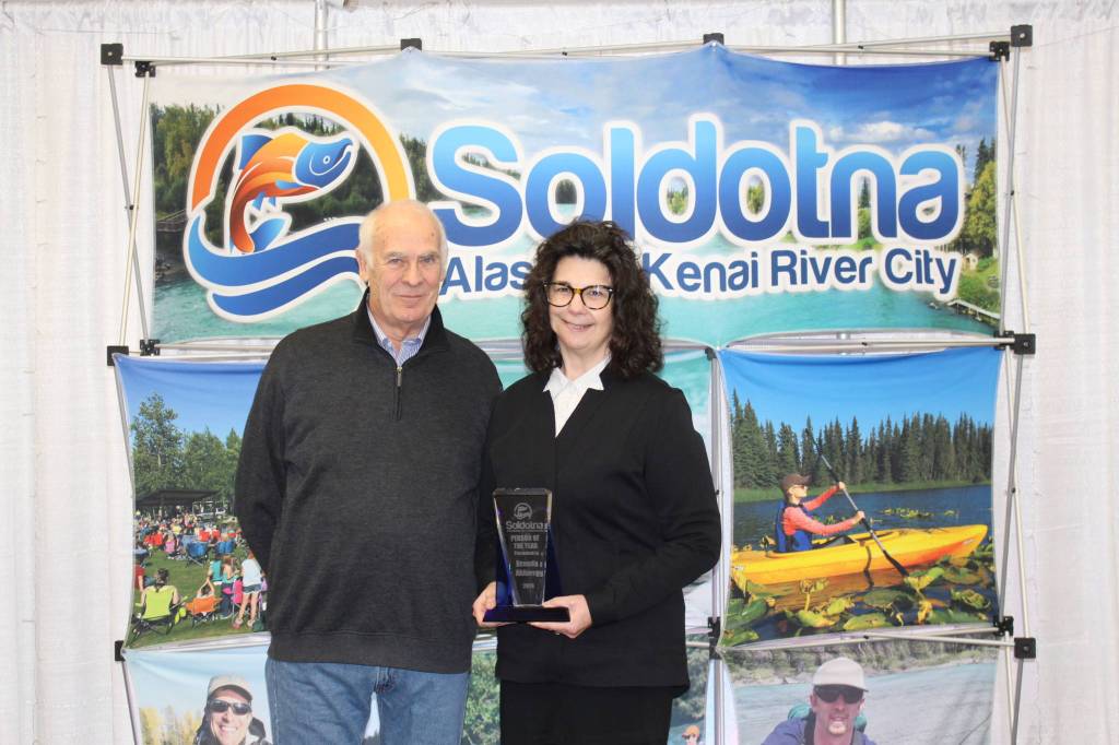 Chamber President Jim Stogsdill and Person of the Year Brenda Ahlberg smile for the camera at the Soldotna Chamber of Commerce Awards Luncheon at the Soldotna Regional Sports Complex on Dec. 11, 2019. (Photo by Brian Mazurek/Peninsula Clarion)