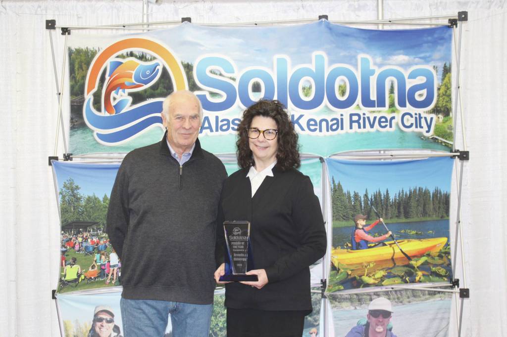 Brian Mazurek / Peninsula Clarion                                Chamber President Jim Stogsdill and Person of the Year Brenda Ahlberg pose at the Soldotna Chamber of Commerce Awards Luncheon at the Soldotna Regional Sports Complex on Wednesday.