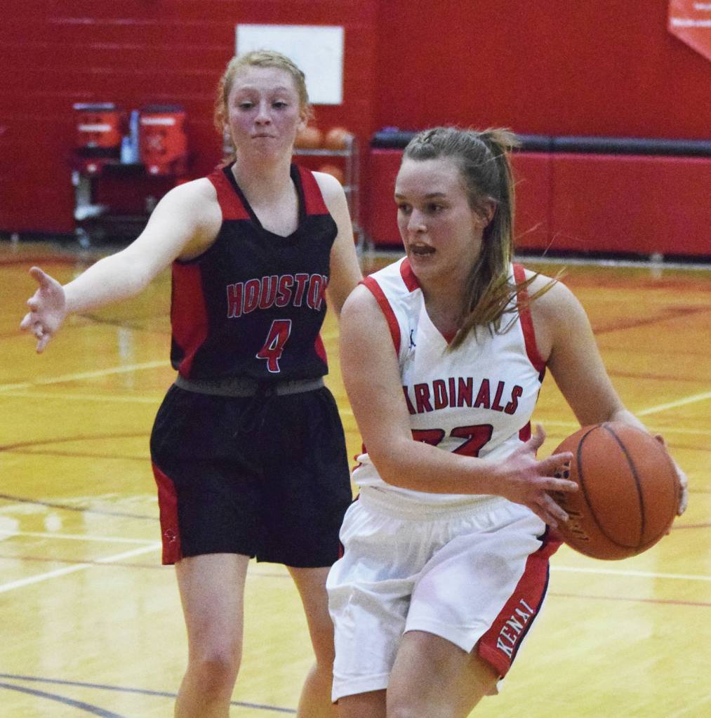 Kenais Jaiden Streiff dribbles by Houstons Denali Whitted, Thursday, Dec. 19, 2019, at the Craig Jung Kenai River Challenge tournament at Kenai Central High School. (Photo by Joey Klecka/Peninsula Clarion)