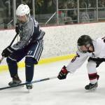 Soldotnas Dylan Dahlgren guards the puck from Kenai Centrals Caden Warren on Friday, Dec. 20, 2019, at the Kenai Multi-Purpose Facility in Kenai, Alaska. (Photo by Jeff Helminiak/Peninsula Clarion)