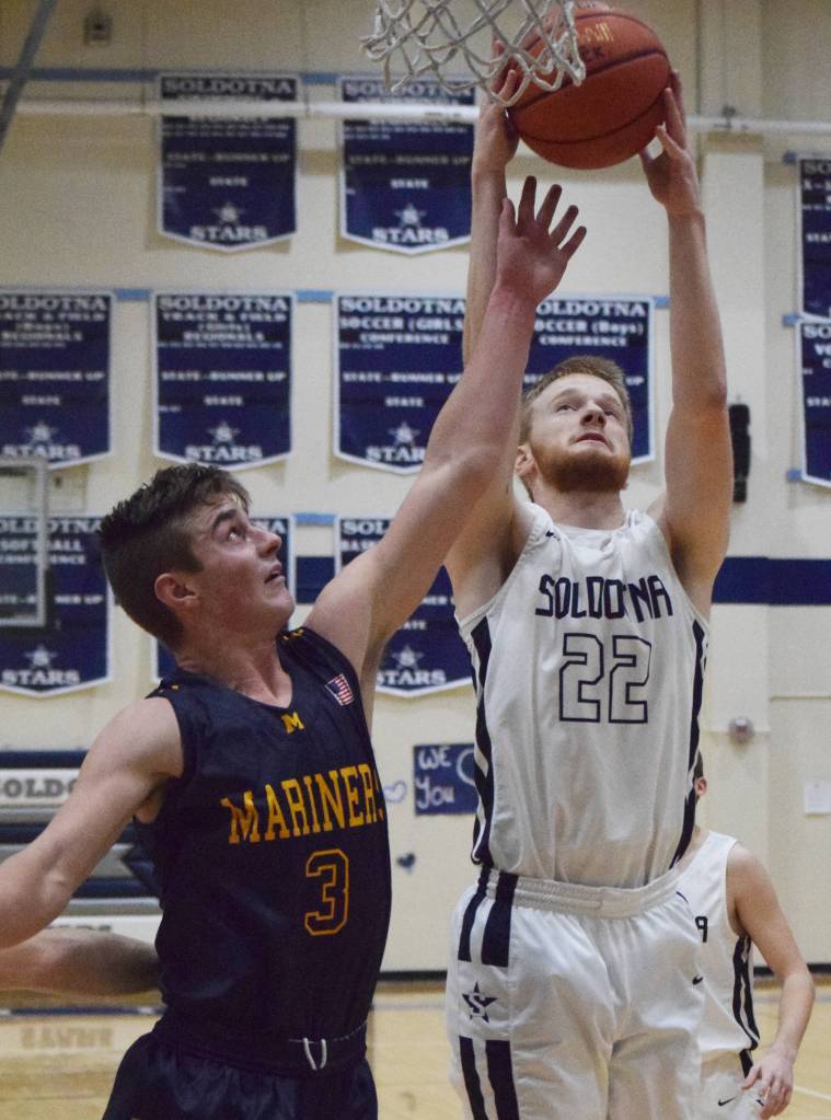 Soldotnas Levi Rosin puts up a shot against Homers Clayton Beachy, Friday, Dec. 20, 2019, at the Powerade/Al Howard Tip-Off tournament at Soldotna High School. (Photo by Joey Klecka/Peninsula Clarion)