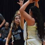 Soldotnas Drysta Crosby-Schneider (30) puts up a block against Dimonds Alissa Pili on March 22 in the Class 4A state basketball tournament at the Alaska Airlines Center in Anchorage. (Photo by Joey Klecka/Peninsula Clarion)