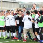 Members of the Kenai boys soccer team dump water on their head coach, Shane Lopez, in celebration of their win over Juneau on May 25 to claim the Division II state soccer championship title. The game was played at Service High School in Anchorage. (Photo by Megan Pacer/Homer News)