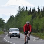 Anchorages John Krellner rides down Gas Well Road with Mount Redoubt in the background Sunday, June 9, 2019, in the Tri-The-Kenai Triathlon in Soldotna, Alaska. (Photo by Joey Klecka/Peninsula Clarion)