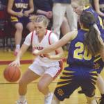 Kenai Centrals Damaris Severson drives on Homers Kelli Bishop and Marina Carroll (20) on Friday, Jan. 10, 2020, at Kenai Central High School in Kenai, Alaska. (Photo by Jeff Helminiak/Peninsula Clarion)