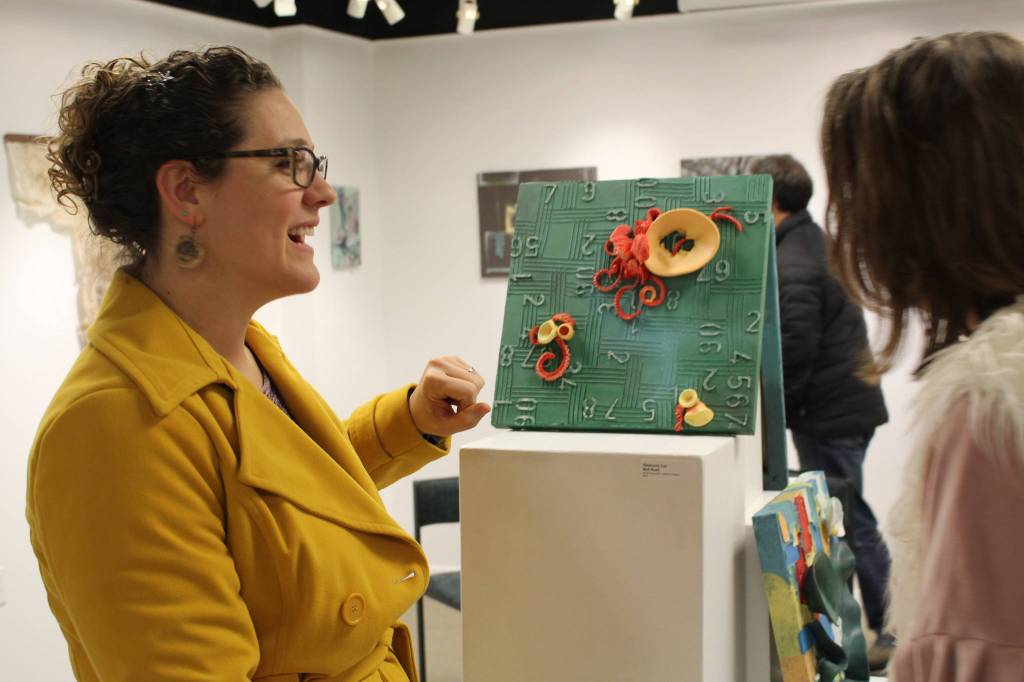 Stephanie Cox displays some of her work at the Kenai Fine Art Center in Kenai, Alaska, on Jan. 2, 2020. (Photo by Brian Mazurek/Peninsula Clarion)