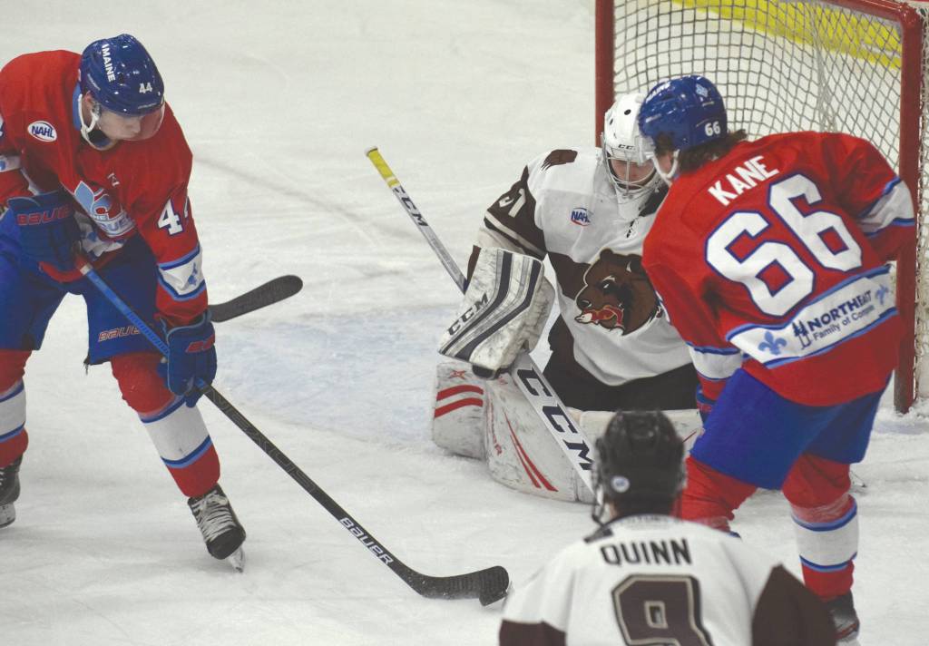 Cannon Green and Noah Kane of the Maine Nordiques attack Kenai River goalie Danny Fraga on Friday, Jan. 18, 2020, at the Soldotna Regional Sports Complex in Soldotna, Alaska. (Photo by Jeff Helminiak/Peninsula Clarion)