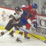 Kenai River Brown Bears defenseman Ryan Reid battles Ignat Belov of the Maine Nordiques for the puck Friday, Jan. 17, 2020, at the Soldotna Regional Sports Complex in Soldotna, Alaska. (Photo by Jeff Helminiak/Peninsula Clarion)