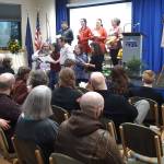 Friends of Dr. Alan Boraas perform a version of the hymn Ill Fly Away translated to the Denaina language during a Celebration of Life for Boraas at Kenai Peninsula College in Soldotna, Alaska on Jan. 17, 2020. (Photo by Brian Mazurek/Peninsula Clarion)