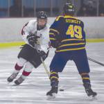 Kenai Centrals Jordan Knudsen brings the puck up against Homers Kazden Stineff on Saturday, Jan. 18, 2020, at the Kenai Multi-Purpose Facility in Kenai, Alaska. (Photo by Jeff Helminiak/Peninsula Clarion)