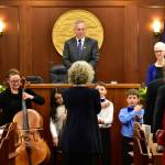 Peter Segall | Juneau Empire                                House Speaker Bryce Edgmon, I-Dillingham, looks on as Juneau Alaska Music Matters students from Glacier Valley School and singers from Sayéik: Gastineau Community School perform Alaskas Flag on Tuesday at the Capitol.