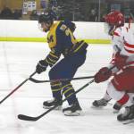 Homers Ethan Pitzman skates the puck away from a pair of defenders during a game against Wasilla Thursday, Jan. 23, 2020, in Wasilla. (Photo by Jeremiah Bartz/Frontiersman)