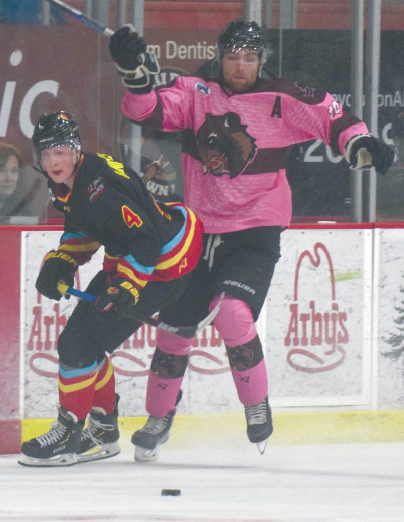 Kenai River Brown Bears forward Laudon Poellinger jumps past New Mexico Ice Wolves defenseman Keegan Langefels on Friday, Jan. 24, 2020, at the Soldotna Regional Sports Complex in Soldotna, Alaska. (Photo by Jeff Helminiak/Peninsula Clarion)
