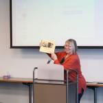 Barbara Waters holds up the book Profiles in Change: Names, Notes, and Quotes for Alaskan Women by Ginna Brelsford while discussing womens history in Alaska during the Centennial Voices event at the Soldotna Public Library in Soldotna, Alaska, on Saturday, Jan. 25, 2020. (Photo by Brian Mazurek/Peninsula Clarion)