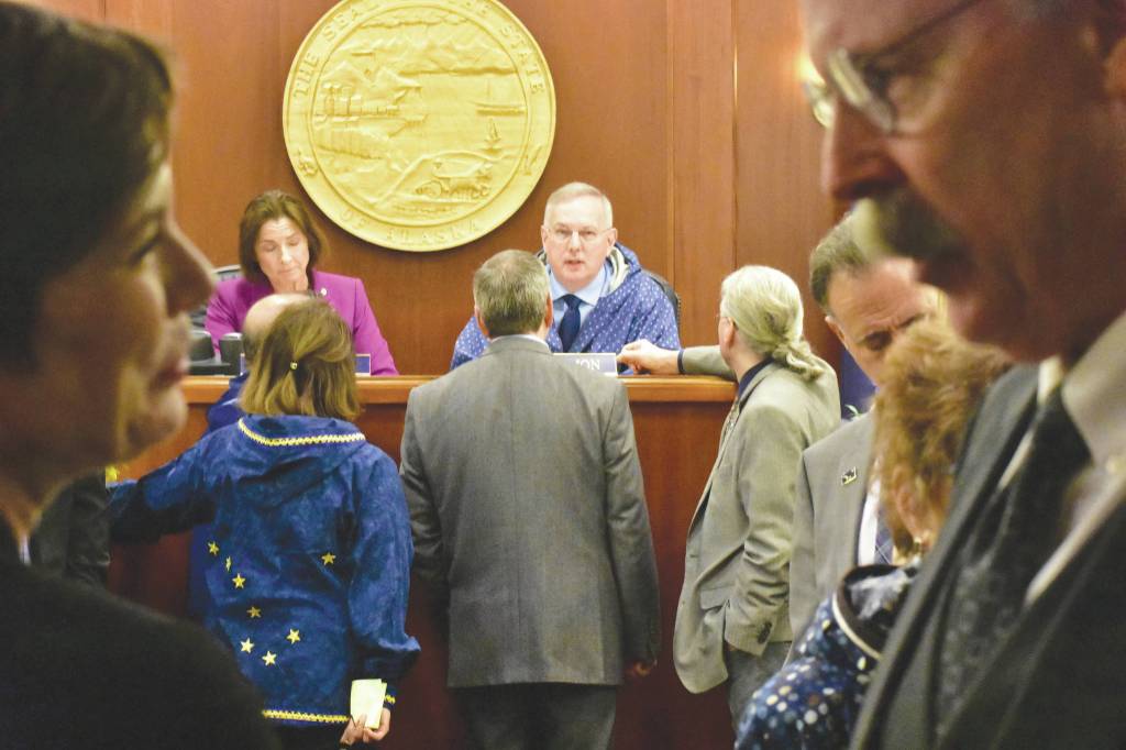 Rep. Spohnholz, D-Anchorage, left, speaks with Sen. Bert Stedman, R-Sitka, during an at ease in a joint session of the House and Senate on Friday. (Peter Segall | Juneau Empire)