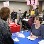 Wanda Seierup, case manager for the Alaska Housing Finance Corporation, speaks with Sandra Groller during the 2020 Project Homeless Connect event at the Soldotna Regional Sports Complex in Soldotna, Alaska, on Jan. 29, 2020. (Photo by Brian Mazurek/Peninsula Clarion)