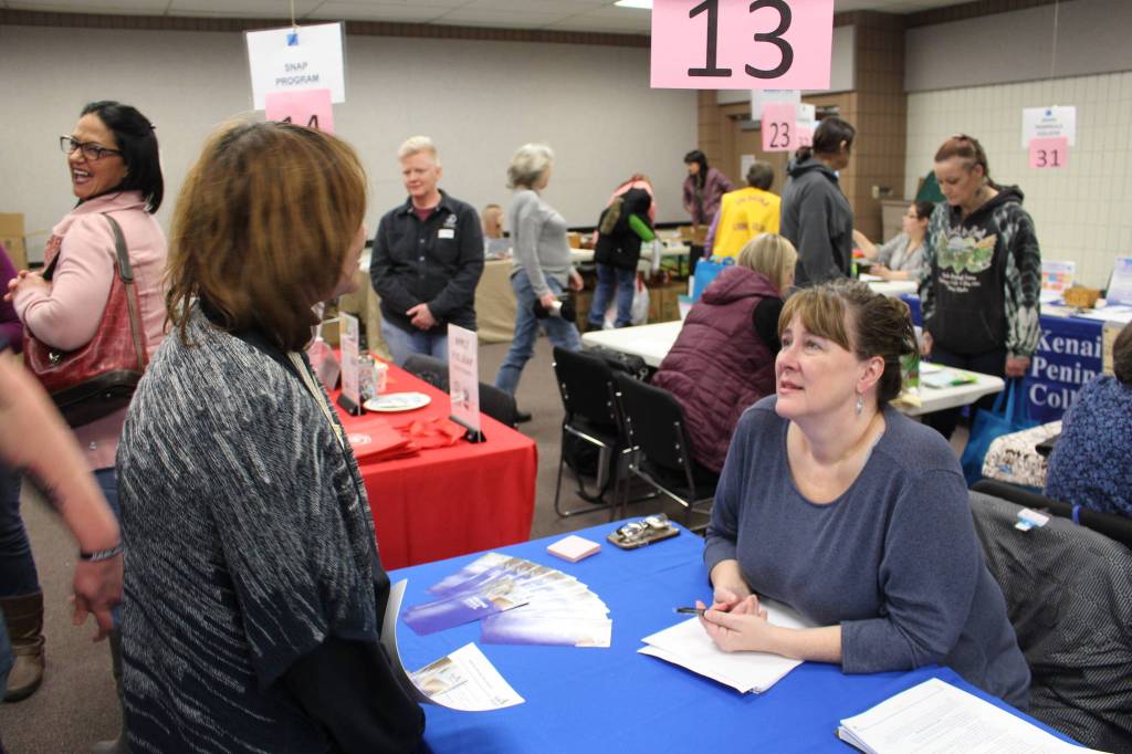 Wanda Seierup, case manager for the Alaska Housing Finance Corporation, speaks with Sandra Groller during the 2020 Project Homeless Connect event at the Soldotna Regional Sports Complex in Soldotna, Alaska, on Jan. 29, 2020. (Photo by Brian Mazurek/Peninsula Clarion)