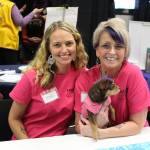 Jennifer Waller, left, Gail Kennedy, right, and Meiko the therapy dog from Freedom House attend the 2020 Project Homeless Connect event at the Soldotna Regional Sports Complex in Soldotna, Alaska, on Jan. 29, 2020. (Photo by Brian Mazurek/Peninsula Clarion)