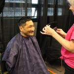 Henry Smith checks out his fresh haircut courtesy of Gail Kennedy during the 2020 Project Homeless Connect event at the Soldotna Regional Sports Complex in Soldotna, Alaska, on Jan. 29, 2020. (Photo by Brian Mazurek/Peninsula Clarion)