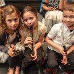 Teagen Kobylarz, Mia Hannevold and Carson Cobb from Soldotna Elementary School play their recorders during Link Up: The Orchestra Rocks! at Kenai Central High School in Kenai, Alaska on Jan. 21, 2017. (Photo courtesy Sue Biggs/Kenai Peninsula Orchestra)