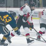Kenais Hunter Erwin, in front of teammate Jordan Knudsen, keeps the puck from Tri-Valleys Mathius Speer on Friday at the Kenai Multi-Purpose Facility in Kenai. (Photo by Jeff Helminiak/Peninsula Clarion)