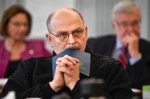 Sen. Click Bishop, R-Fairbanks, rests his head on a Constitution of Alaska booklet as he listens to Donna Arduin, Director of the Office of Management and Budget, and Mike Barnhill, policy director for the OMB, present Gov. Mike Dunleavy’s budget to the Senate Finance Committee at the Capitol on Tuesday, Feb. 18, 2019. Senate President Cathy Giessel, R - Anchorage, left, and Sen. Gary Stevens, R-Kodiak, right, are in the background. (Michael Penn | Juneau Empire)