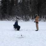 Brian Mazurek, left, and Ben Weagraff, right, are seen ice fishing on Paddle Lake off of Swan Lake Road in Sterling, Alaska on Feb. 2, 2020. (Photo by Victoria Petersen/Peninsula Clarion)