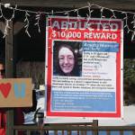 Wes Schacht, a friend and tenant of Sara and Ed Berg, stands next to a missing poster of Anesha Duffy Murnane in the gazebo at WKFL Park during a candlelight vigil in Homer, Alaska, on Saturday, Feb. 1, 2020. (Photo by Delcenia Cosman)