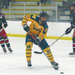kHomerճ Isaiah Nevak drives away from North Poleճ Blake Battcher (3) and Ethan Frollo (24) on Friday night during the second period of a semifinal of the ASAA/First National Cup Division II State Championships at the University of Alaska Fairbanks Patty Ice Arena. (Photo by Danny Martin/Fairbanks Daily News-Miner)