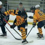 Homers Ethan Pitzman (26) and Matey Reutov (67) battle with Soldotnas Dylan Dahlgren (left) for the puck during the second period of Saturday nights final of the ASAA/First National Cup Division II State Hockey Championships at the University of Alaska Fairbanks Patty Ice Arena. (Photo by Danny Martin/News-Miner)