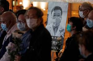 People wearing masks, attend a vigil for Chinese doctor Li Wenliang, in Hong Kong, Friday, Feb. 7. The death of a young doctor who was reprimanded for warning about Chinas new virus triggered an outpouring Friday of praise for him and fury that communist authorities put politics above public safety. (AP Photo | Kin Cheung)