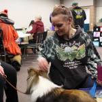 Pam Rickard visits with Collette the therapy dog during the 2020 Project Homeless Connect event at the Soldotna Regional Sports Complex in Soldotna, Alaska, on Jan. 29, 2020. (Photo by Brian Mazurek/Peninsula Clarion)