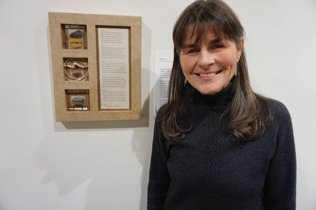 Susan Campbell stands next to her box construction and poem, Listen on Feb. 4, 2020, at the Pratt Museum in Homer, Alaska. It was created in response to composer Jennifer Wrights From the Darkness We Sing the Mighty Land into Being. Her work is part of Denali Artists Respond to Music Inspired by Wilderness, a collaboration between artists and composers showing Feb. 7-May. 25, 2020, at the Pratt Museum in Homer, Alaska. (Photo by Michael Armstrong/Homer News)