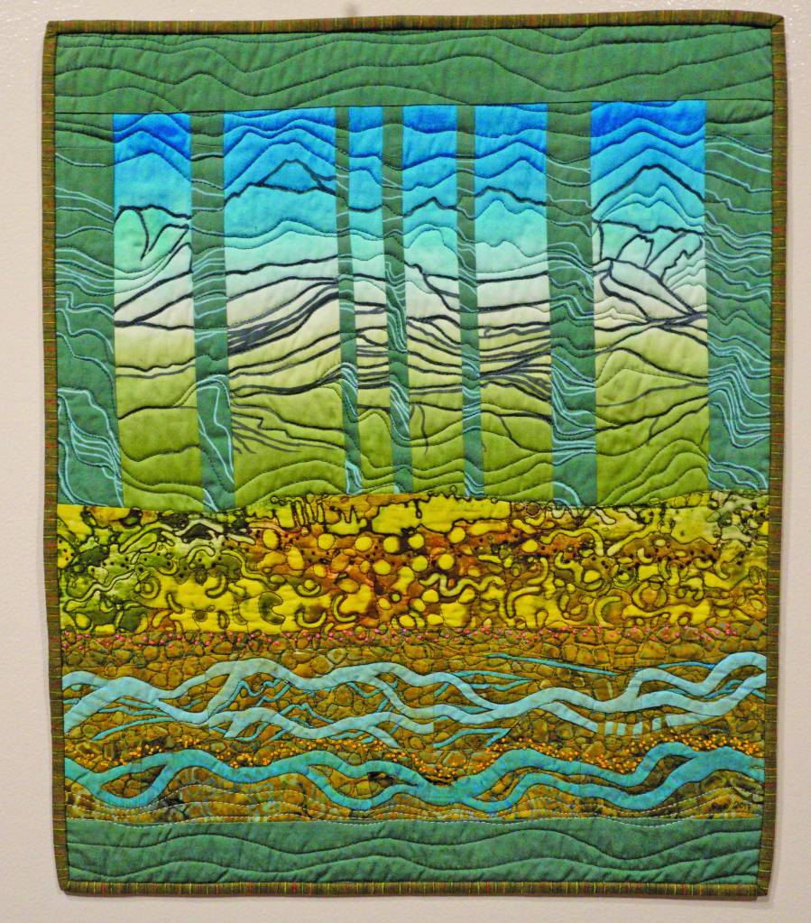 Ree Nancarrows art quilt, Memories, was created in response to composer Dawn Sonntags Tattler Creek. Her work is part of Denali Artists Respond to Music Inspired by Wilderness, a collaboration between artists and composers showing Feb. 7-May 25, 2020, at the Pratt Museum in Homer, Alaska. (Photo by Michael Armstrong/Homer News)                                Susan Campbell stands next to her box construction and poem, Listen, on Feb. 4 at the Pratt Museum in Homer. Her piece was created in response to composer Jennifer Wrights From the Darkness We Sing the Mighty Land into Being. Her work is part of Denali Artists Respond to Music Inspired by Wilderness, a collaboration between artists and composers showing Feb. 7-May 25 at the Pratt. (Photo by Michael Armstrong/Homer News)