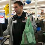 Brian Lauth, closing manager for Super Bear Supermarket IGA, bags groceries Thursday, Feb. 13, 2020. Super Bear will be collecting donations to ship food to Southeast Alaska communities impacted by a lack of ferry service. (Ben Hohenstatt | Juneau Empire)