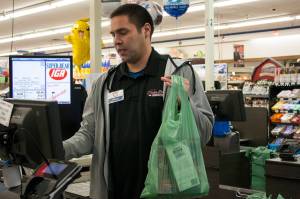 Brian Lauth, closing manager for Super Bear Supermarket IGA, bags groceries Thursday, Feb. 13, 2020. Super Bear will be collecting donations to ship food to Southeast Alaska communities impacted by a lack of ferry service. (Ben Hohenstatt | Juneau Empire)