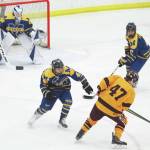Homers Bergen Knutson (left) and Toby Nevak (right) try to fend off Dimonds Kaden Daniels during a Friday game at the 2020 ASAA First National Cup Division I Hockey State Championship at the Curtis D. Menard Memorial Sports Center in Wasilla. (Photo by Megan Pacer/Homer News)