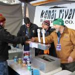 Sean Owens, right, serves up a Tsalteshi Trail Ale to Nate Mole, left, during the 2020 Frozen RiverFest at Soldotna Creek Park in Soldotna, Alaska on Feb. 15, 2020. (Photo by Brian Mazurek/Peninsula Clarion)