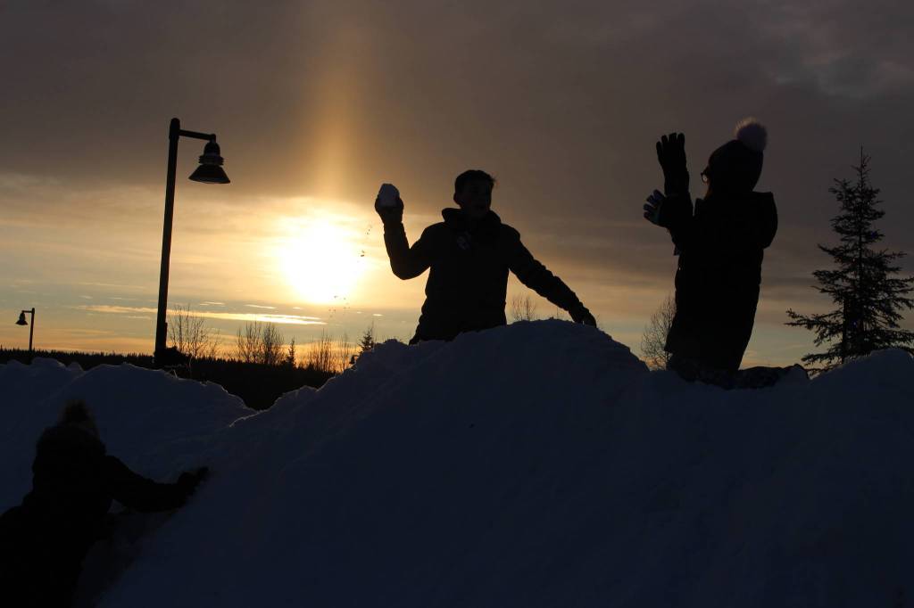 Brooklyn Stewart, left, and Camryn Mcgee, right, engage in a snowball fight during the 2020 Frozen RiverFest at Soldotna Creek Park in Soldotna, Alaska on Feb. 15, 2020. (Photo by Brian Mazurek/Peninsula Clarion)