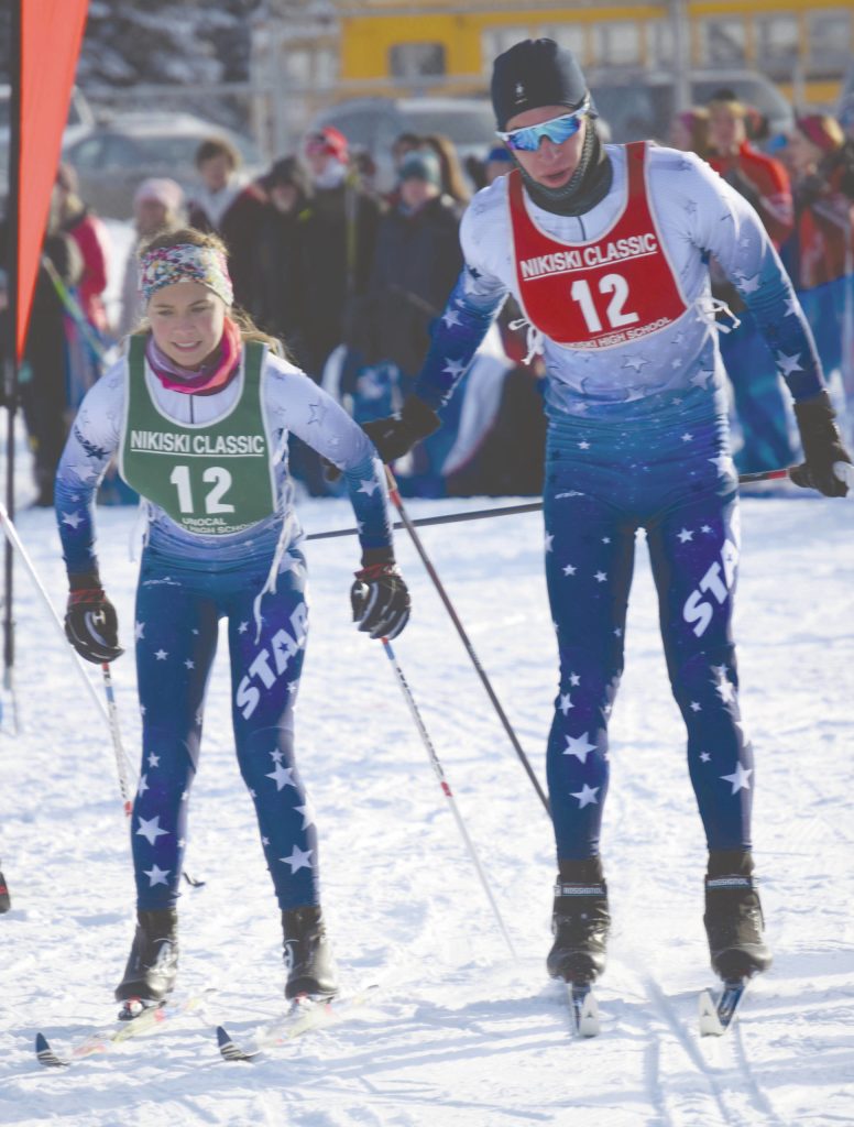 Soldotnas David Grinestaff tags Jordan Strausbaugh in the relay zone at the Kenai Peninsula Borough Nordic Ski championships Saturday, Feb. 15, 2020, at Tsalteshi Trails just outside of Soldotna, Alaska. (Photo by Jeff Helminiak/Peninsula Clarion)