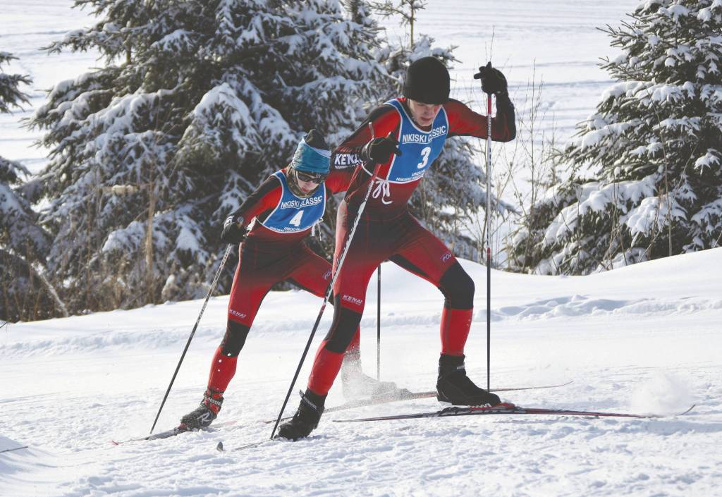 Kenais Mathew Grybowski and Nathan Haakenson climb a hill at the Kenai Peninsula Borough Nordic ski championships Saturday, Feb. 15, 2020, at Tsalteshi Trails just outside of Soldotna, Alaska. (Photo by Jeff Helminiak/Peninsula Clarion)