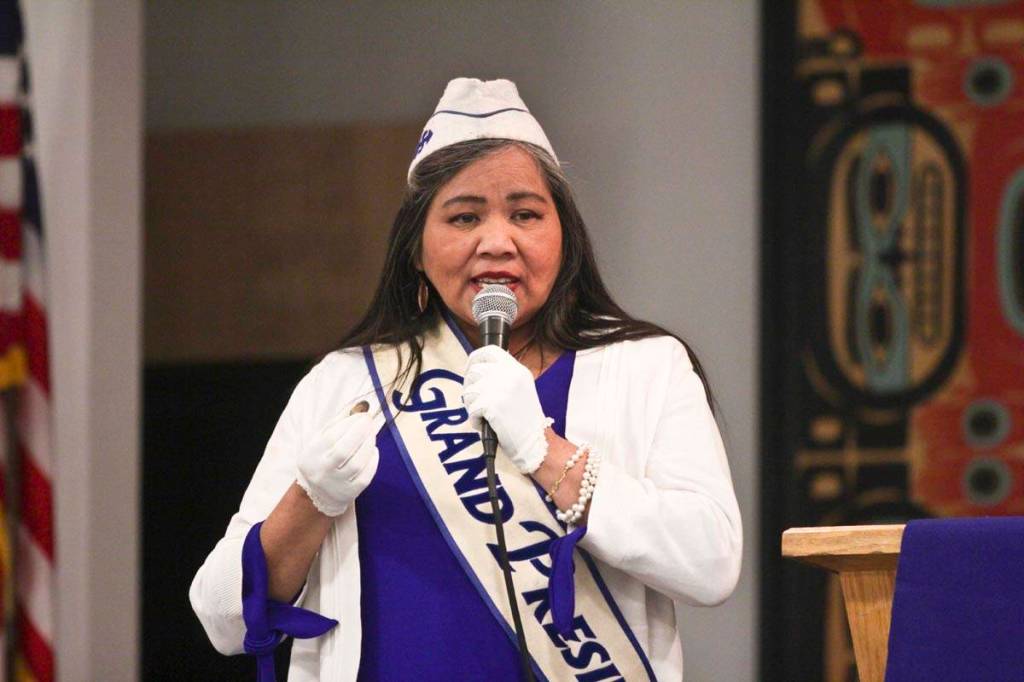 Alaska Native Sisterhood Grand Camp President Paulette Moreno, holding a newly minted $1 gold Elizabeth Peratrovich coin, addresses the crowd during the Elizabeth Peratrovich Day celebration at the Tlingit and Haida Community Council Sunday. (Michael S. Lockett | Juneau Empire)